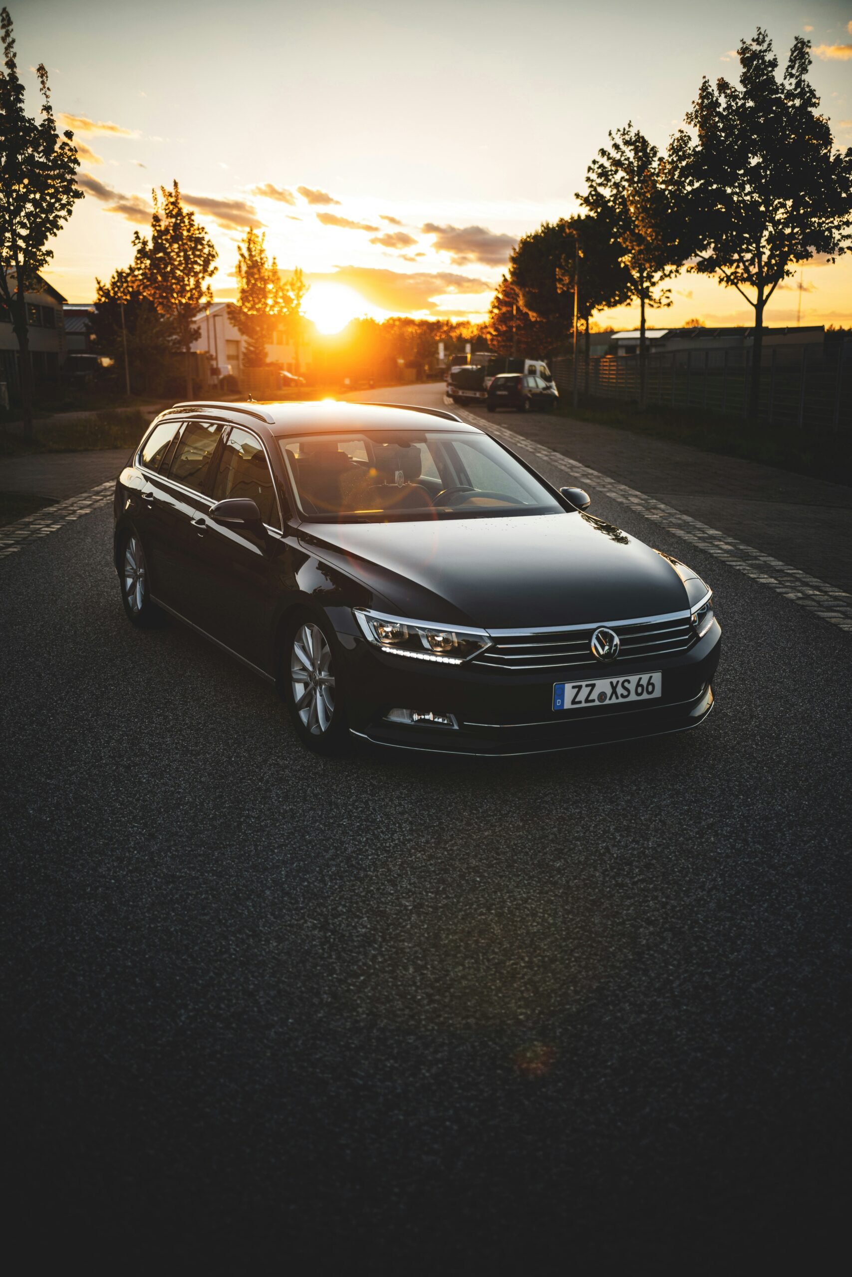 black mercedes benz sedan on road during sunset