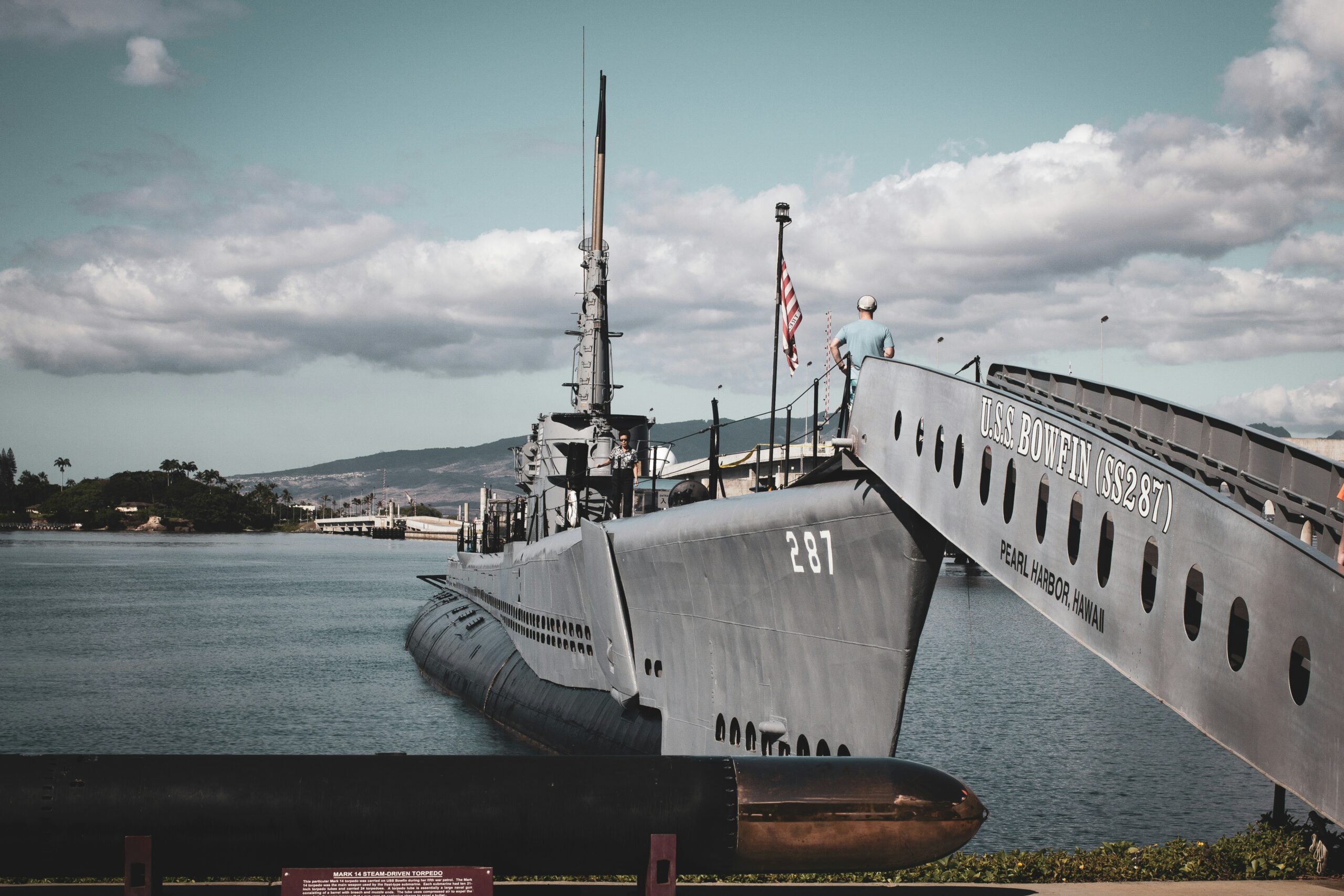 grey warship on dock during daytime