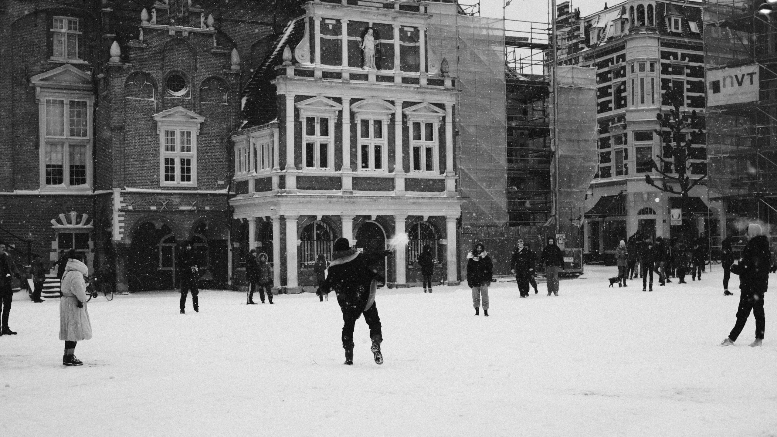 people walking on snow covered field near building during daytime