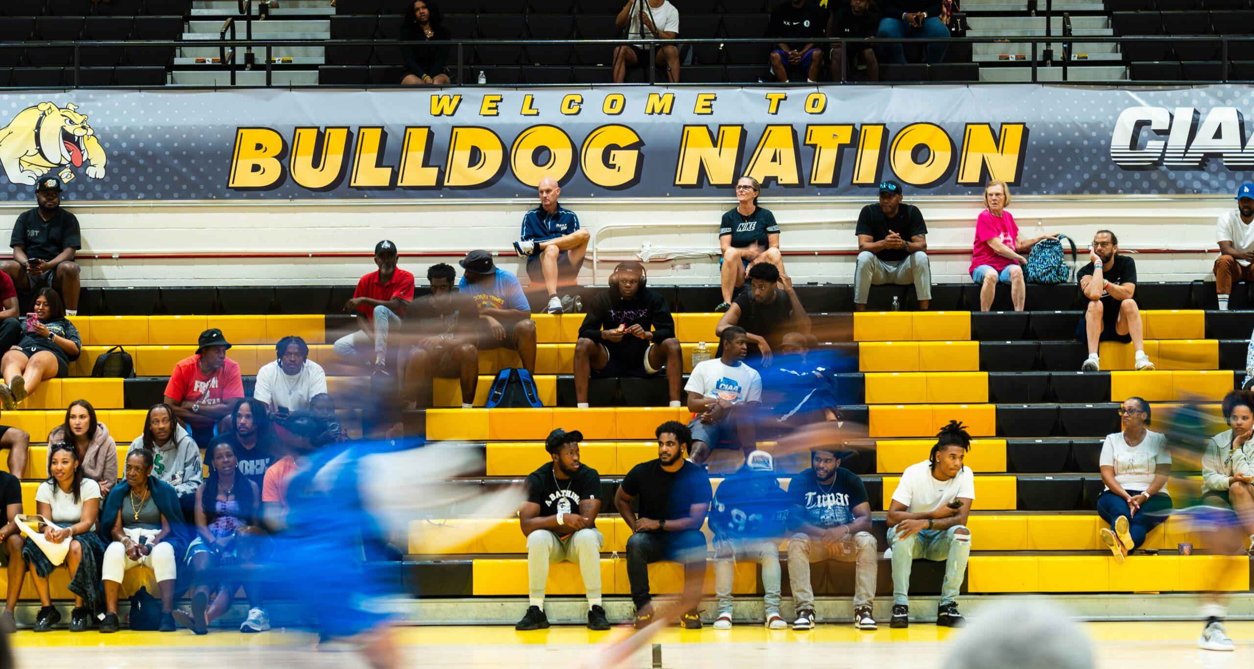 A blurry photo of a volleyball player hitting a ball