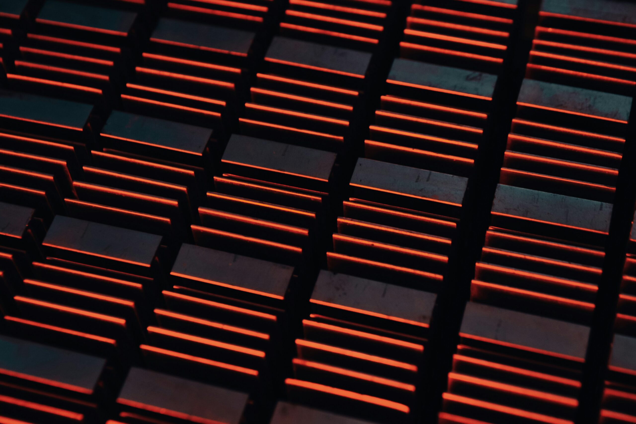 a close up of a metal grate with red lights