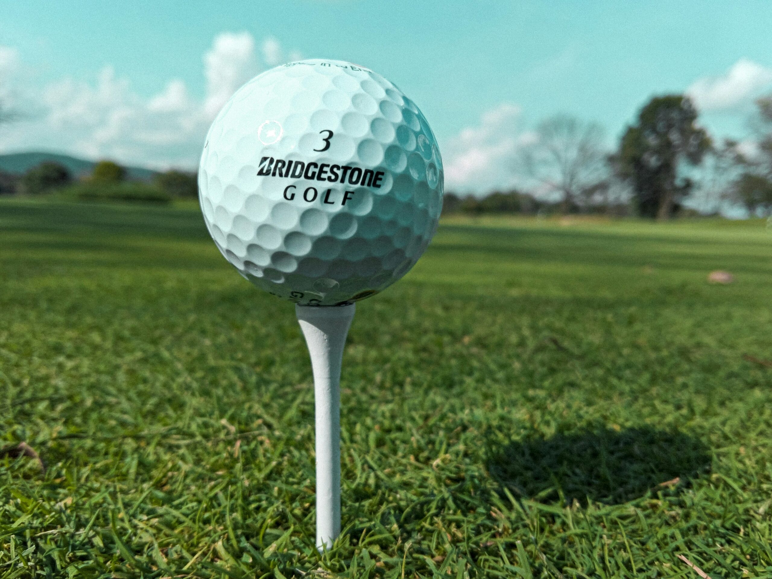 a golf ball sitting on top of a white tee