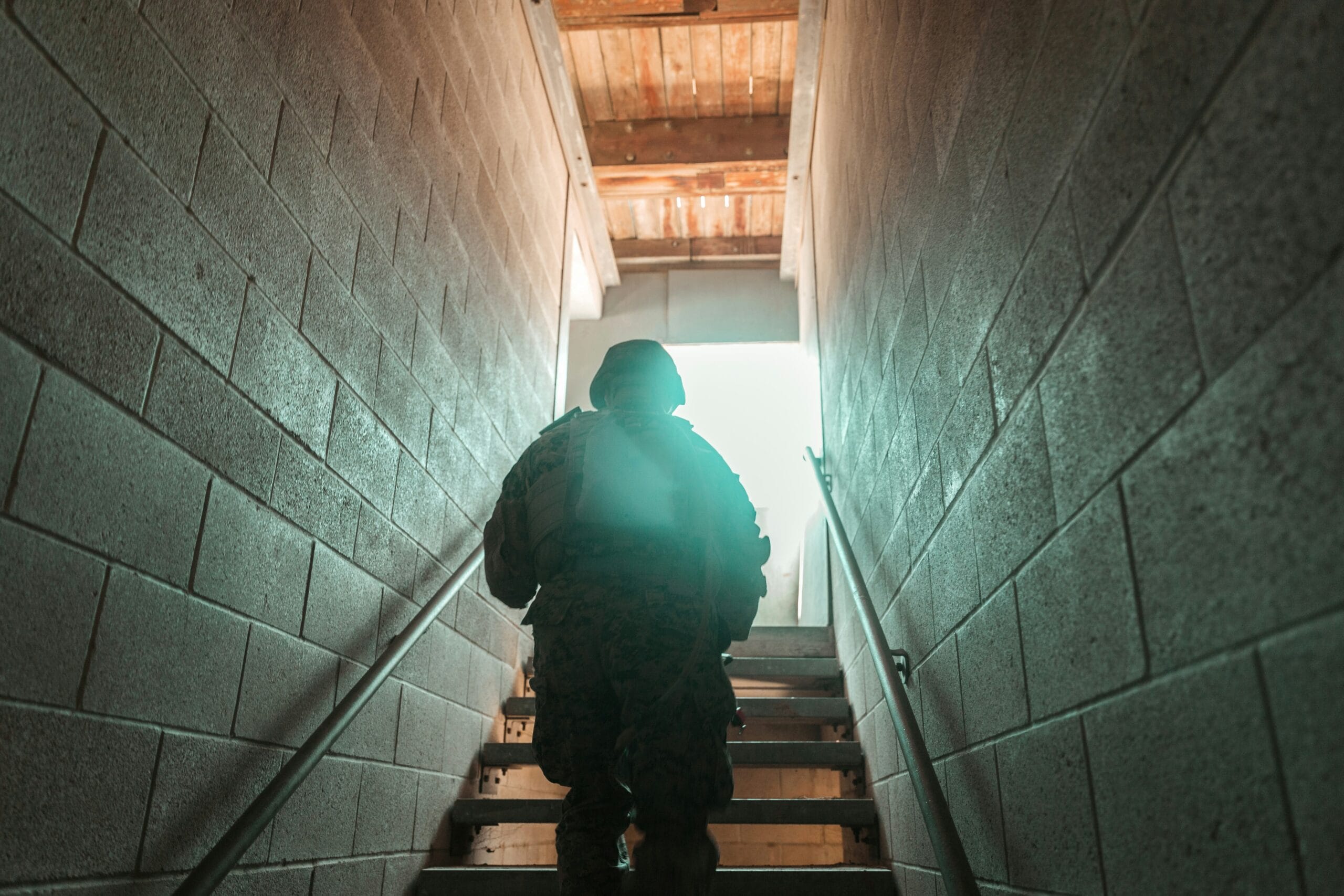 man in black jacket walking on staircase