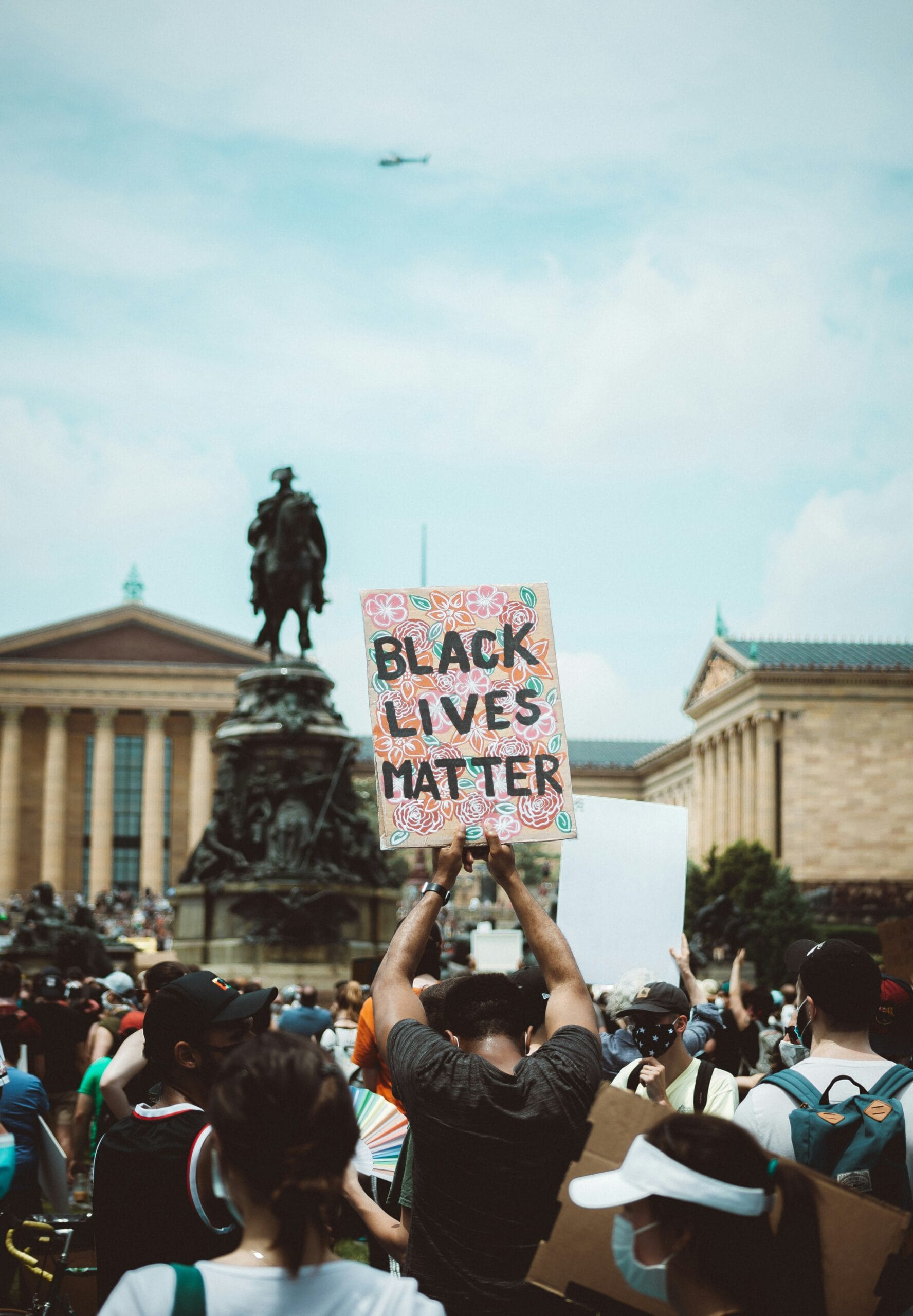 people holding white and black printed banner during daytime