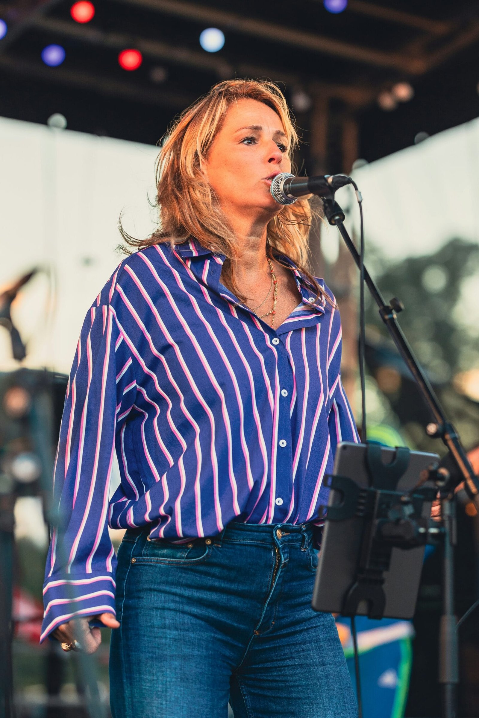 A woman standing in front of a microphone