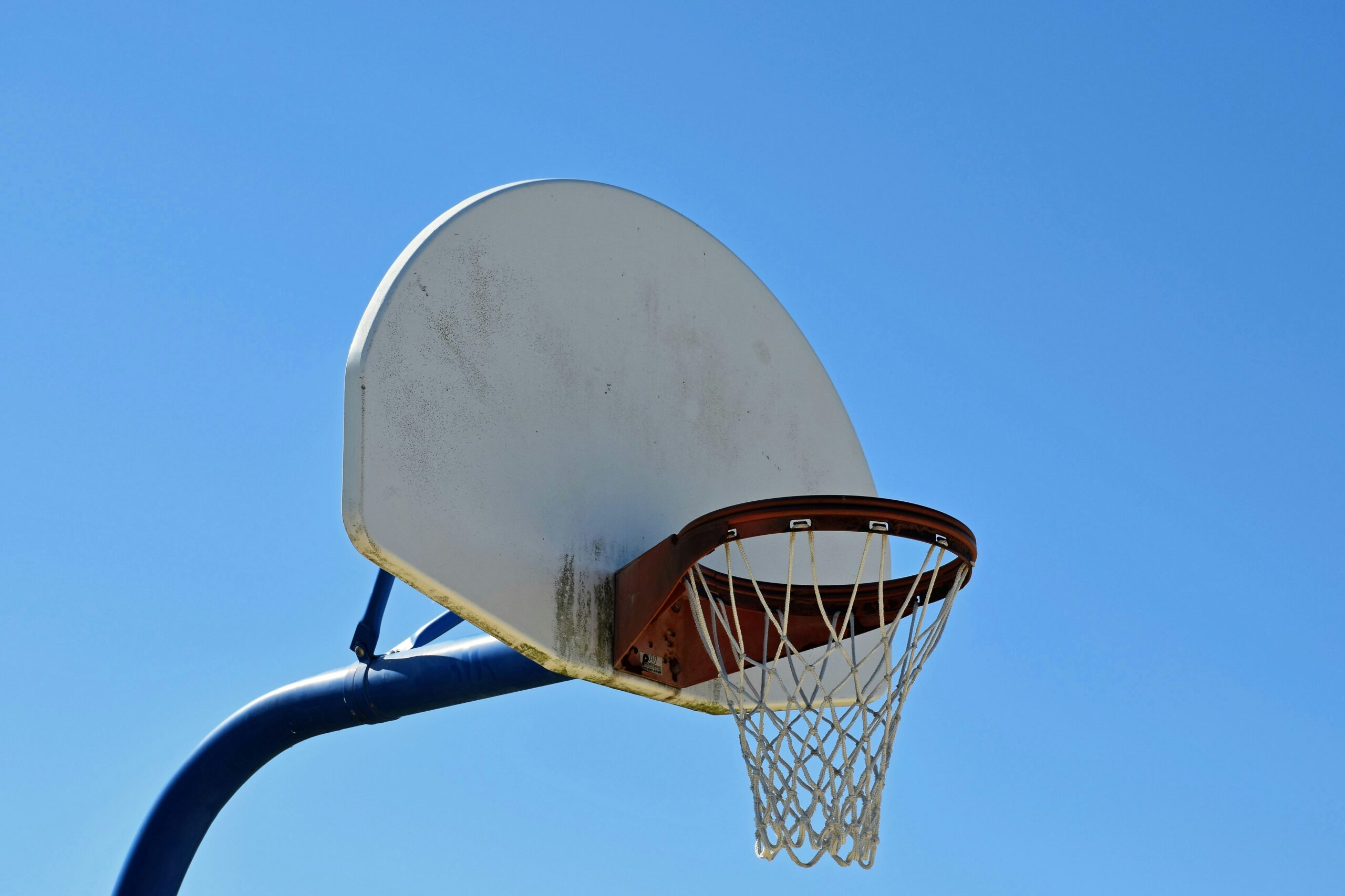 a basketball hoop with a blue sky in the background