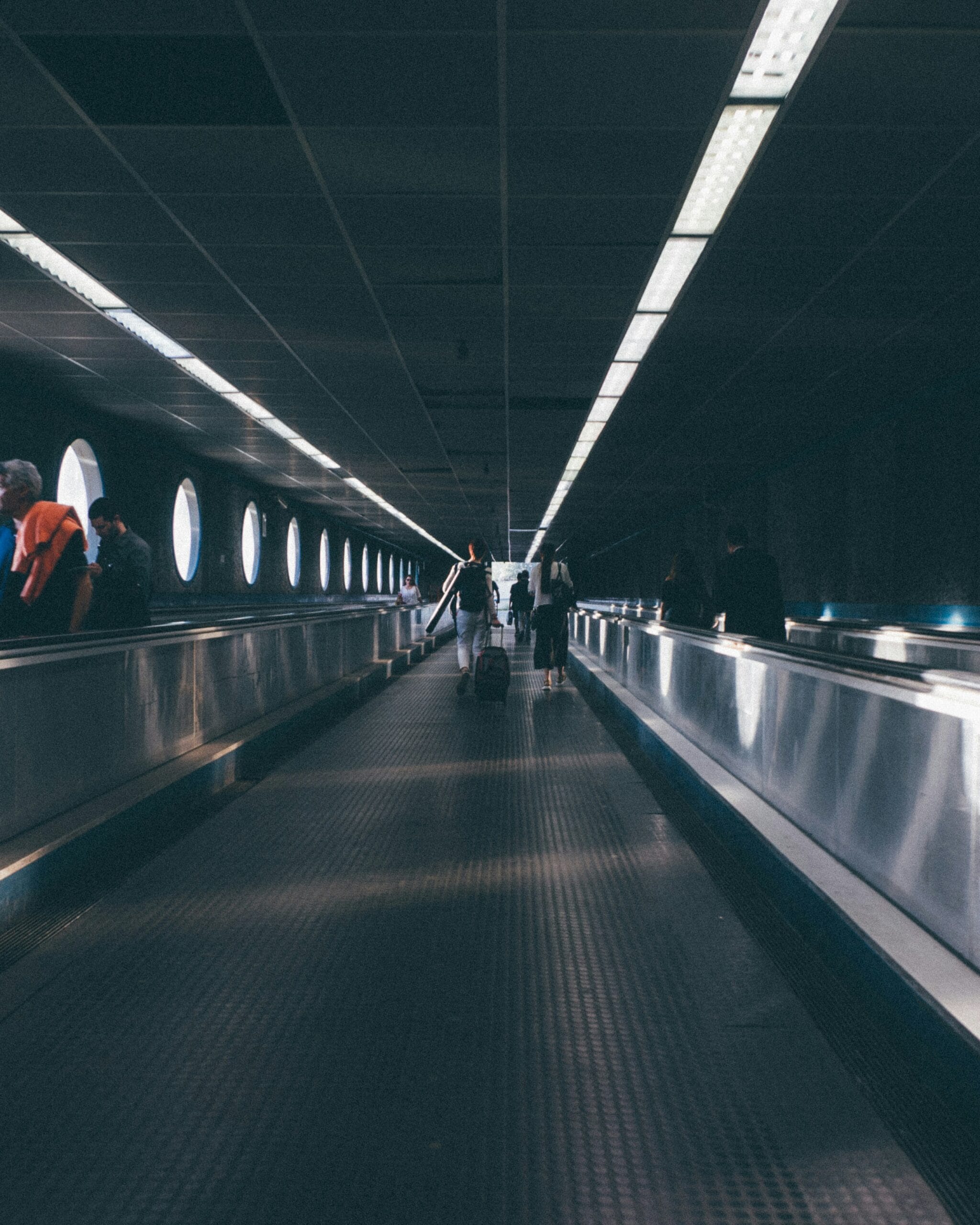 a group of people walking down an escalator