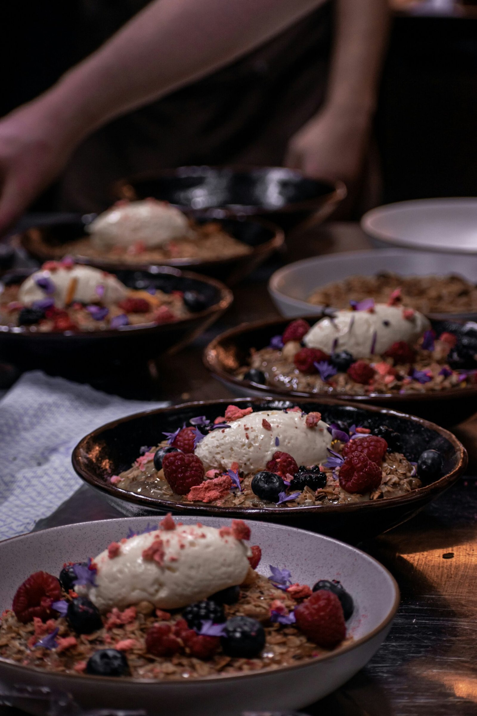 white and red floral food on black ceramic bowl