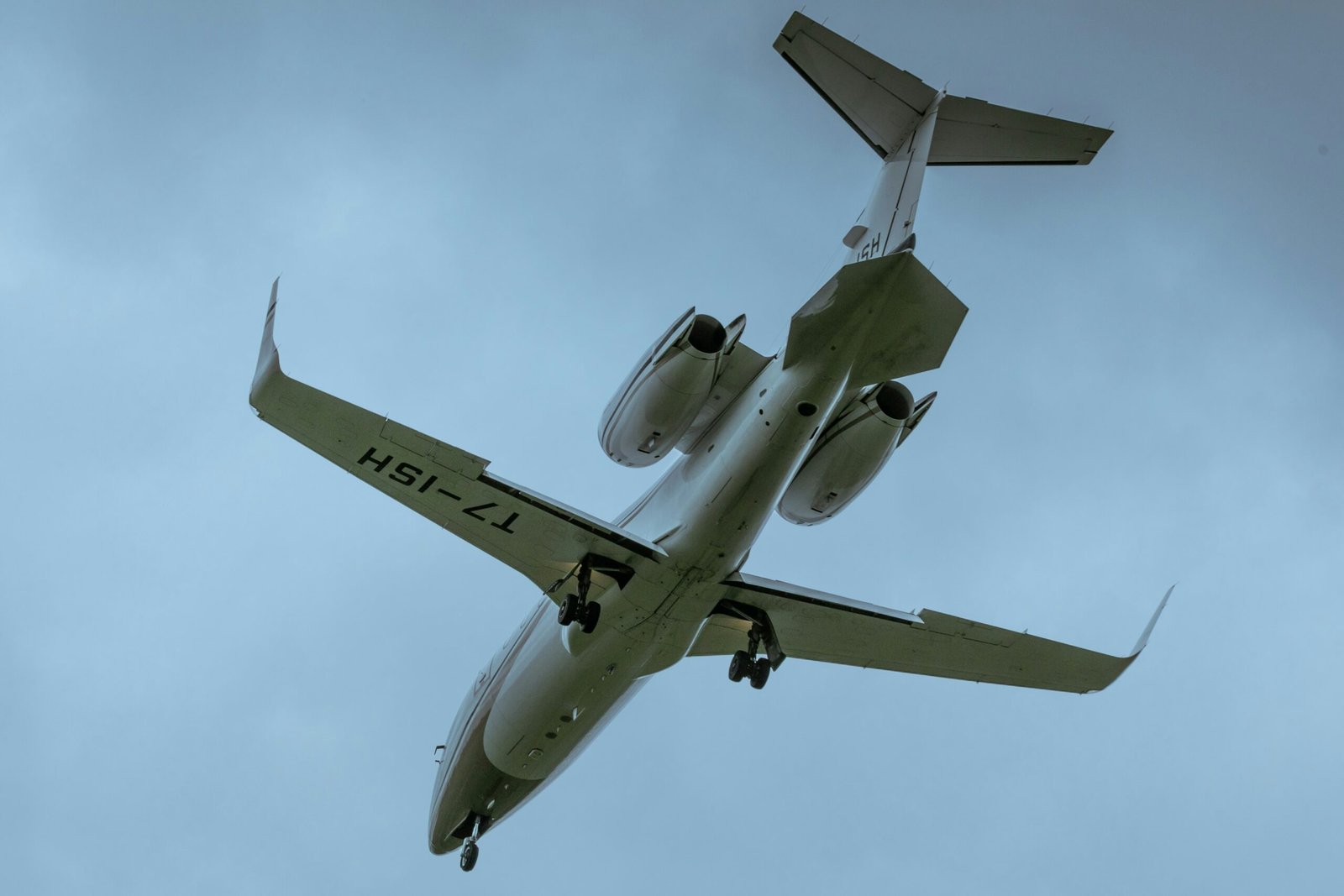 a large jetliner flying through a cloudy blue sky